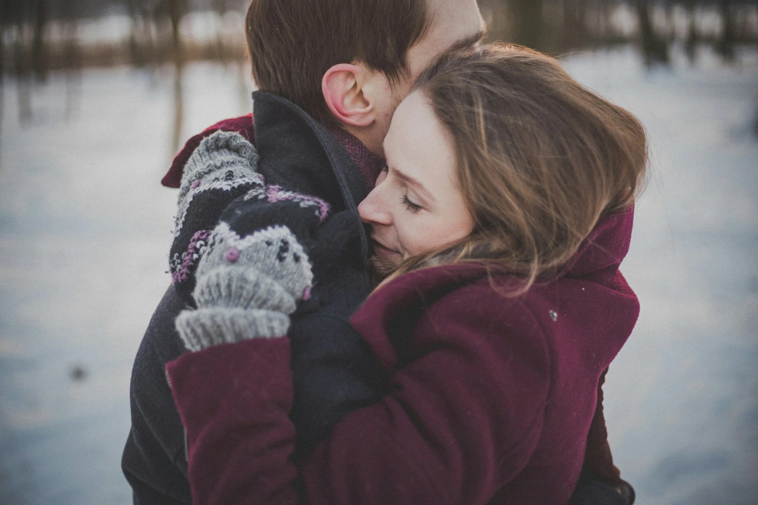 A couple embracing outdoors in winter light — the kind of closeness the method is built to preserve.